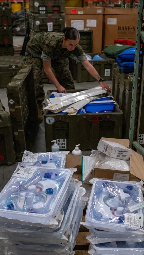 U.S. Navy Sailors with 2nd Medical Logistics Company, 2nd Supply Battalion, 2nd Marine Logistics Group, load medical kits on Camp Lejeune, N.C., March 18, 2020. The Sailors are preparing kits to provide for national coronavirus aid alongside II Marine Expeditionary Force and will include hand sanitizer gel, surgical masks, disinfectant wipes, latex gloves, sphygmomanometers, stethoscopes, thermometers, and isolation gowns.  (U.S. Marine Corps photo by Cpl. Rachel K. Young-Porter)
