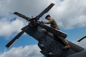 Photo of an Airman performing a preflight inspection.