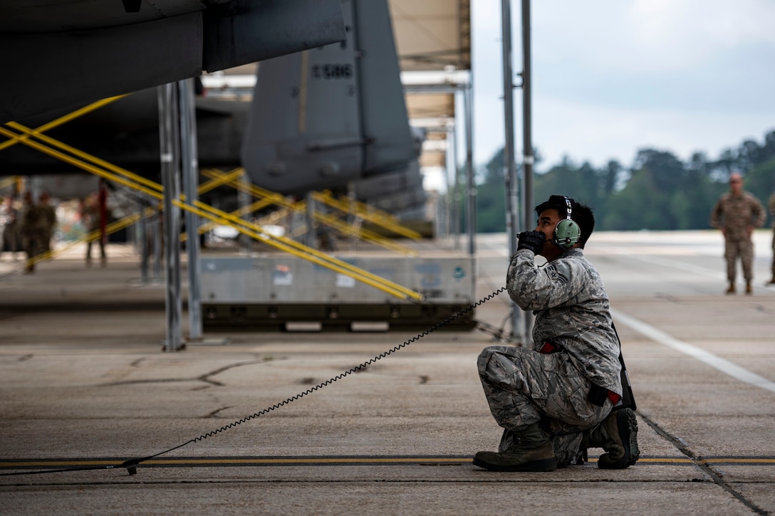 Photo of Airman performing preflight checks.