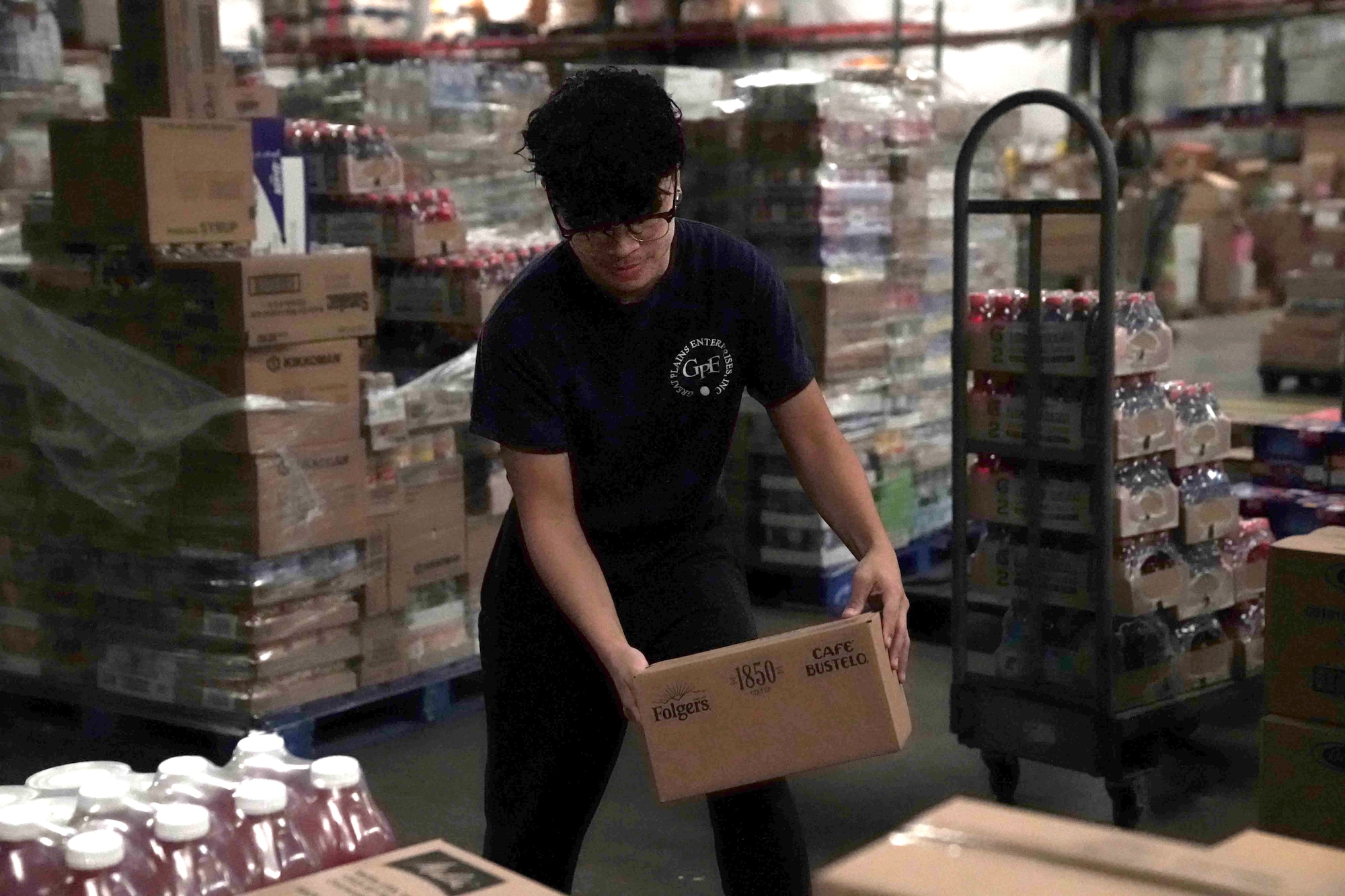 Angelo Manlangit, a stock room sorter, unpacks pallets in the commissary warehouse on Nellis Air Force Base, Nevada, March 24, 2020. Since the COVID-19 pandemic, the commissary receives pallets daily and restocks the shelves to replenish items for the morning rush. (U.S. Air Force photo by Senior Airman Stephanie Gelardo)
