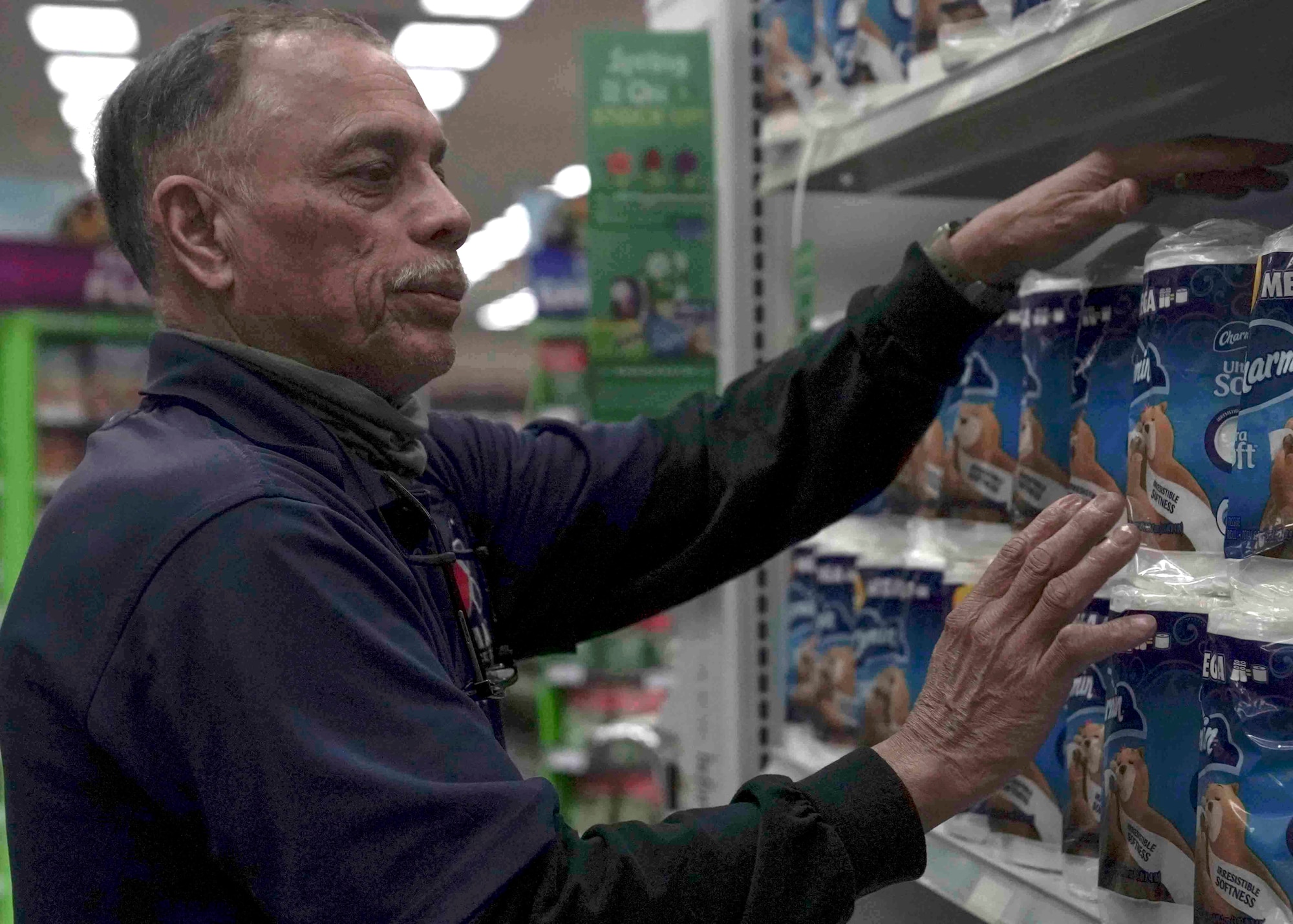 Rich Vega, stockroom manager, restocks toilet paper in the Exchange on Nellis Air Force Base, Nevada, March 25, 2020. The Exchange and commissary have prioritized restocking high-demand items, such as toilet paper and hand sanitizer, which sell out quickly during the COVID-19 pandemic. (U.S. Air Force photo by Senior Airman Stephanie Gelardo)