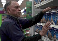 Rich Vega, stockroom manager, restocks toilet paper in the Exchange on Nellis Air Force Base, Nevada, March 25, 2020. The Exchange and commissary have prioritized restocking high-demand items, such as toilet paper and hand sanitizer, which sell out quickly during the COVID-19 pandemic. (U.S. Air Force photo by Senior Airman Stephanie Gelardo)