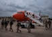 Basic Military Training graduates off load from a plane at Sheppard Air Force Base, Texas, March 27, 2020. Usually the newest Airmen will arrive by bus to Sheppard, but to mitigate exposure Air Education and Training command opted to transport them via air lift. The airlines are contracted with the Air Force to pick up the Airmen in Lackland and transport them to Sheppard, Keesler AFB and other training bases. (U.S. Air Force photo by Senior Airman Pedro Tenorio)