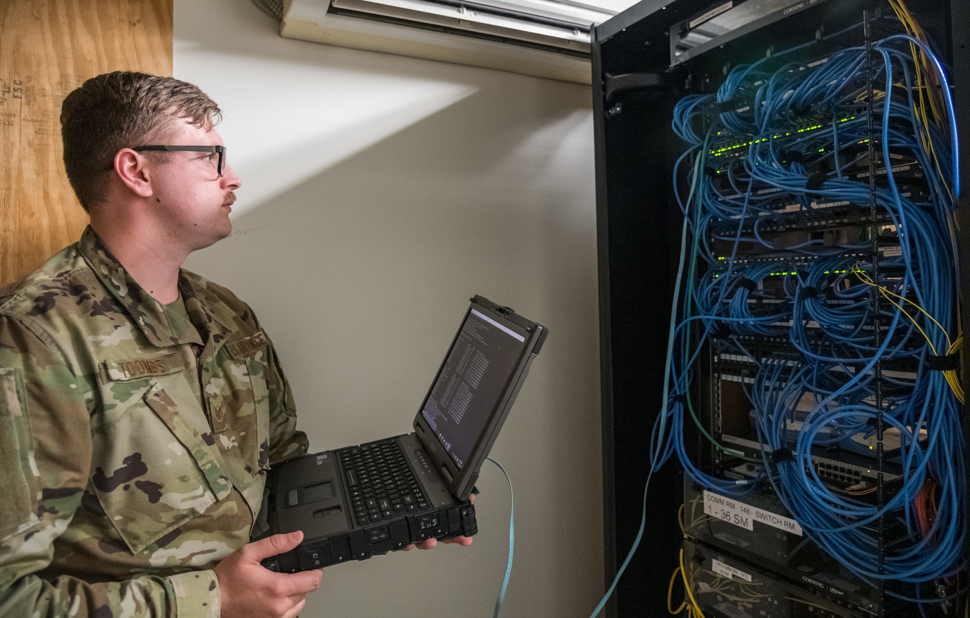 Staff Sgt. Joseph Toombs, 436th Communications Squadron cyber transport supervisor, verifies configurations of network equipment March 26, 2020, on Dover Air Force Base, Delaware. Toombs and other 436th CS personnel ensured that both personnel required to be at work had connectivity to the base network while others teleworked from home to mitigate the spread of COVID-19. (U.S. Air Force photo by Roland Balik)