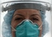 A portrait of an Air Force nurse wearing facial protective gear