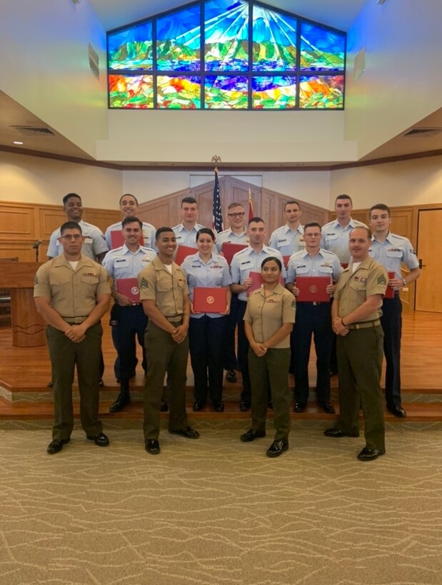 U.S. Airmen assigned to Joint Base Pearl Harbor-Hickam, Hawaii, graduate from the U.S. Marine Corps Enlisted Professional Military Education Lance Corporal Leadership and Ethics Seminar at Marine Corps Base Hawaii Chapel March 13, 2020. This marks the first time Airmen have participated in the two week leadership course. (U.S. Air Force photo by 2nd Lt. Benjamin Aronson)