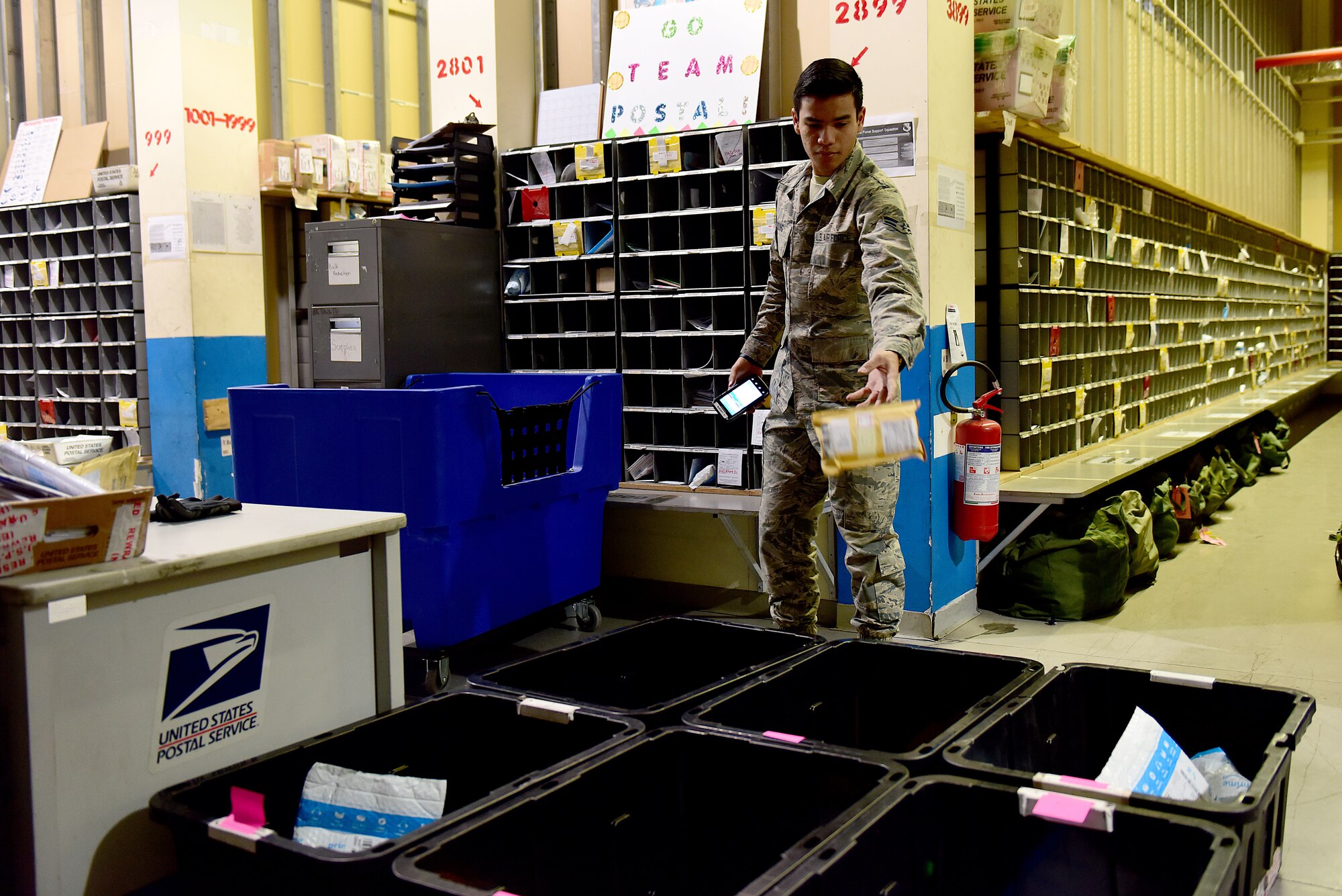 U.S. Air Force Airman 1st Class Daniel Young, 31st Force Support Squadron postal clerk, sorts packages for delivery at the Aviano Post Office, Aviano Air Base, Italy, March 25, 2020. The Aviano post office operates as an extension of the United States Postal Service, providing postal services to service members, dependents, and Department of Defense civilians overseas during both normal and contingency operations. (U.S. Air Force photo by Staff Sgt. Kelsey Tucker)