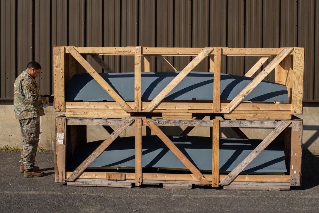 Staff Sgt. Johnny Barber, 727th Air Mobility Squadron combat readiness deployment manager, checks the cargo movement documents of two aircraft panels March 24, 2020, at RAF Mildenhall, England. The air freight shop of the air mobility squadron receives assets essential to continued mission accomplishment . (U.S. Air Force photo by Airman 1st Class Joseph Barron)