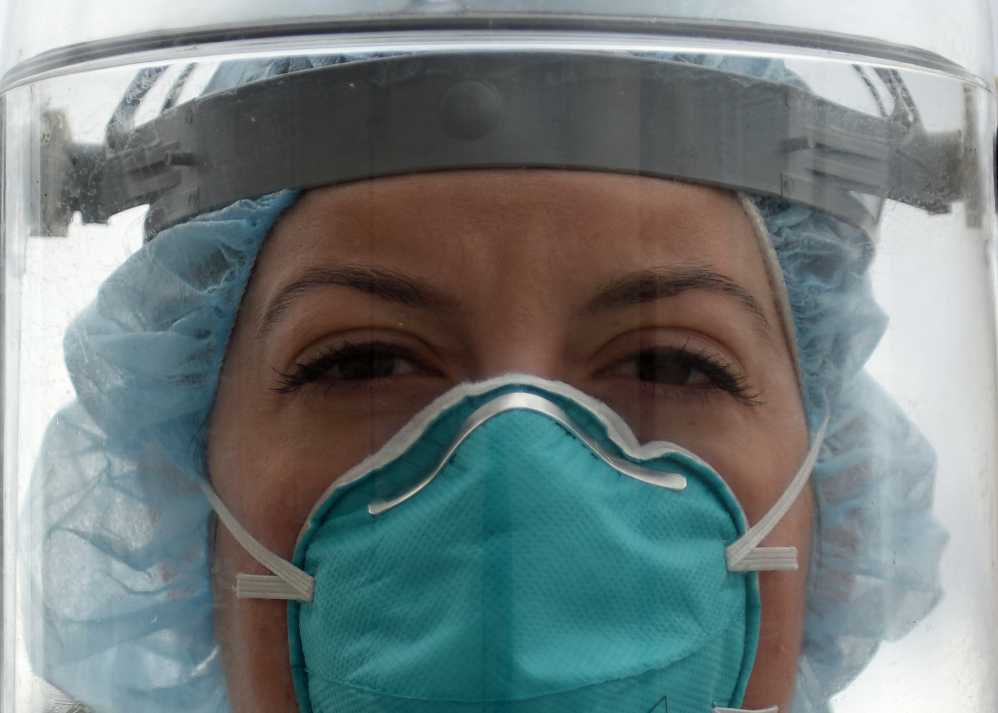A portrait of an Air Force nurse wearing facial protective gear.