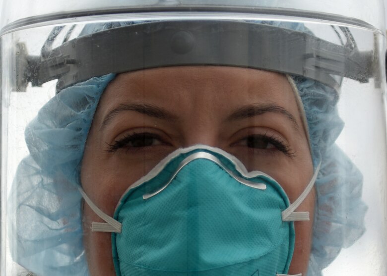 A portrait of an Air Force nurse wearing facial protective gear