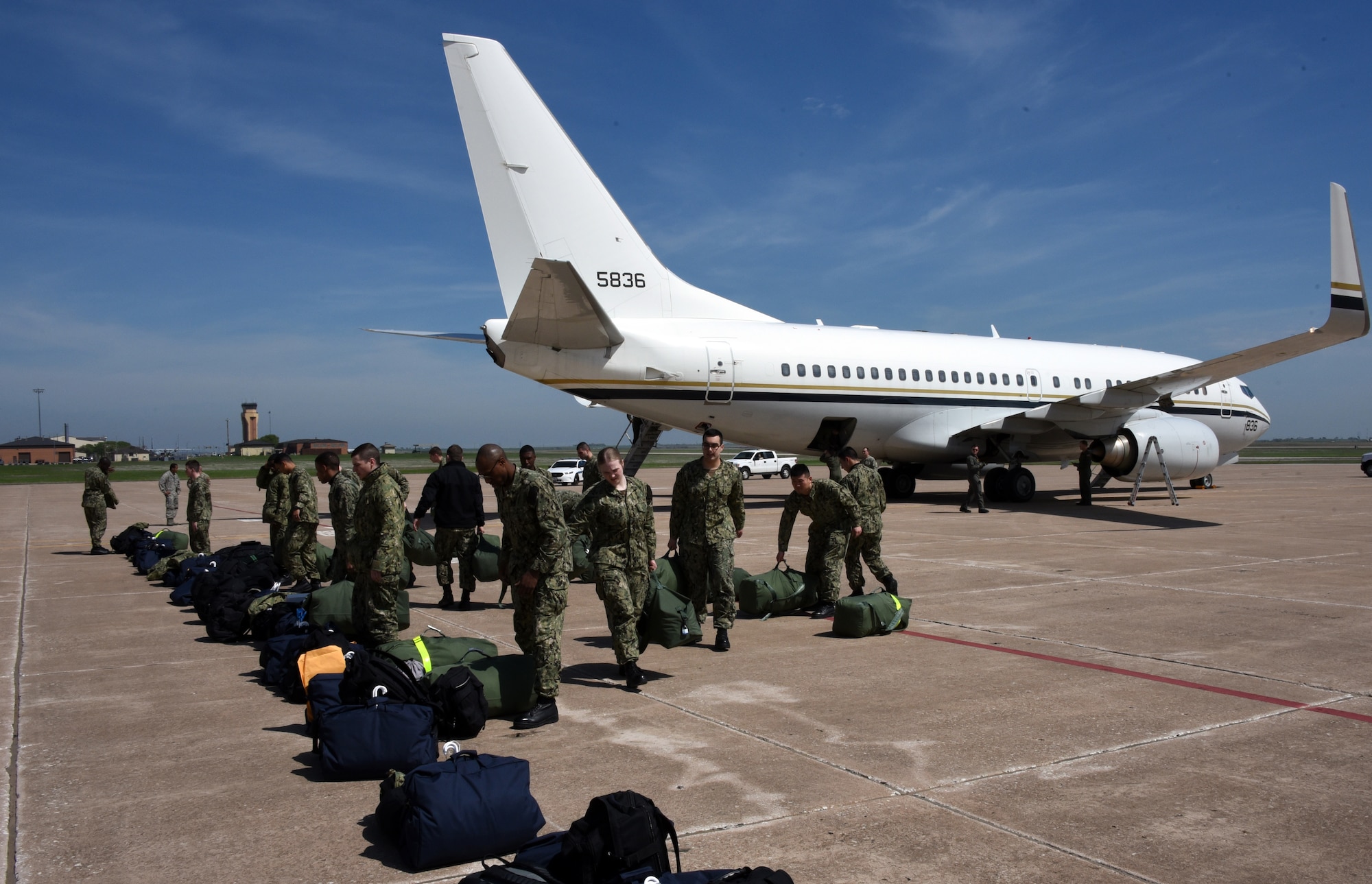 Sailors unload from an airplane to Sheppard Air Force Base, Texas, March 27, 2020. The sailors arrived from boot camp to continue their technical training at Sheppard. To help mitigate exposure to COVID-19 they were air lifted instead of the usual bus drive. (U.S. Air Force photo by Senior Airman Pedro Tenorio