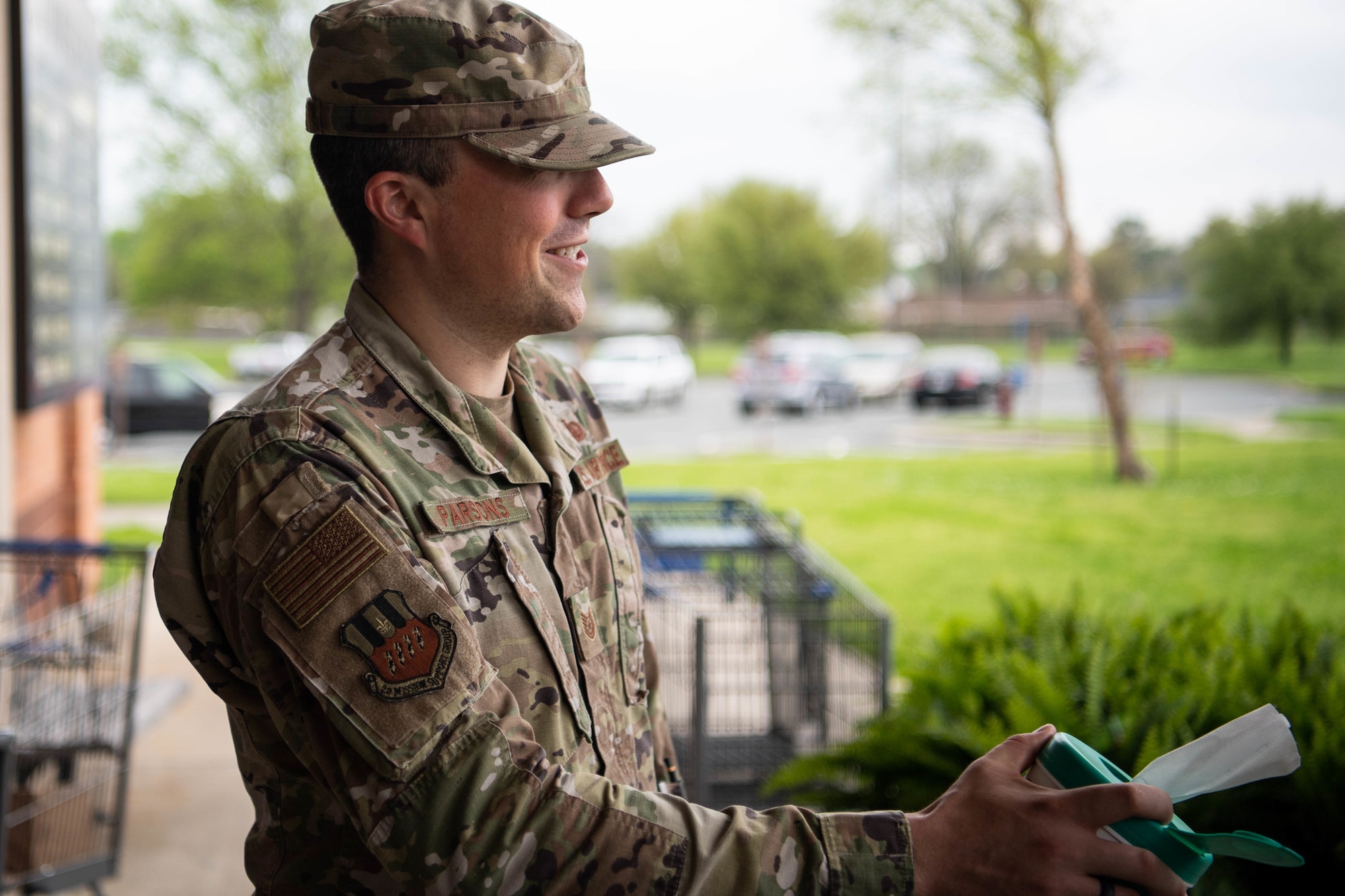 Tech. Sgt. Tom Parsons, 2nd Mission Support Group executive assistant, hands out sanitizing wipes at the commissary at Barksdale Air Force Base, La., March 24, 2020. The Barksdale commissary has implemented a number of safety guidelines to stop the spread of germs, including: sanitizing registers and door handles more frequently than normal, marking lines on the floor to ensure people keep a six foot distance and even making routine intercom announcements to remind customers of common health guidelines. (U.S. Air Force photo by Airman 1st Class Jacob B. Wrightsman)