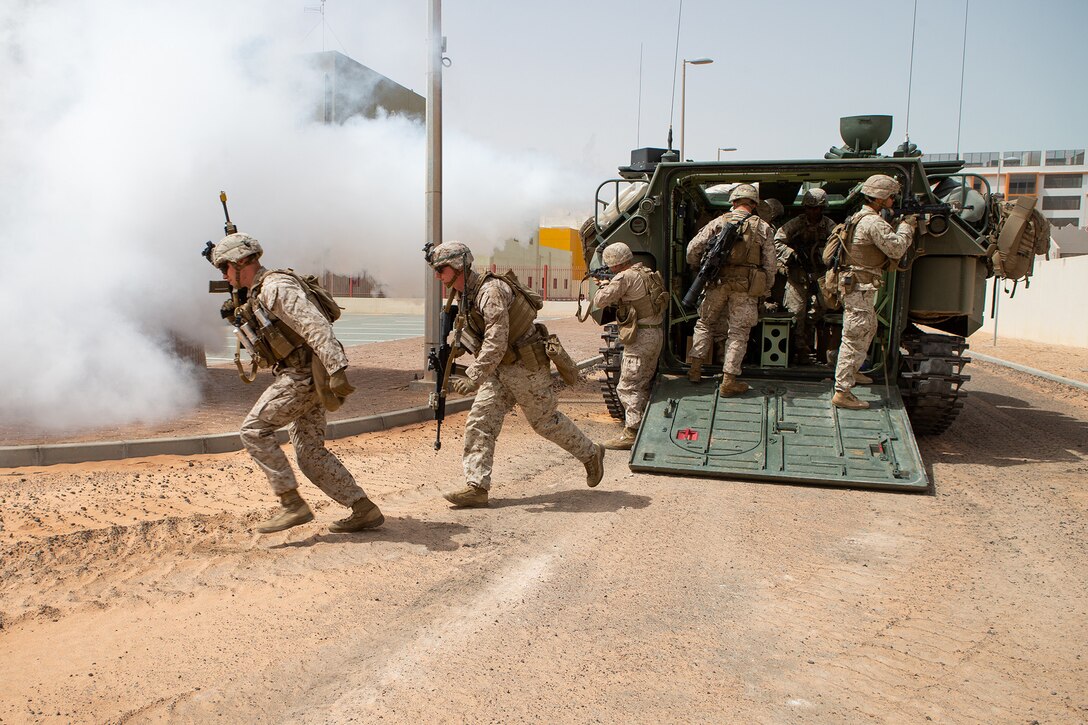 U.S. Marines with Charlie Company, 1st Battalion, 1st Marine Regiment, dismount an AAV-P7/A1 assault amphibious vehicle while participating in an urban operations assault demonstration during exercise Native Fury 20 in the United Arab Emirates, March 23, 2020. Native Fury 20 is a joint, bilateral exercise with the United Arab Emirates Armed Forces demonstrating the ability to respond to contingencies, natural disasters and other crises in the region. (U.S. Marine Corps photo by Lance Cpl. Brendan Mullin)