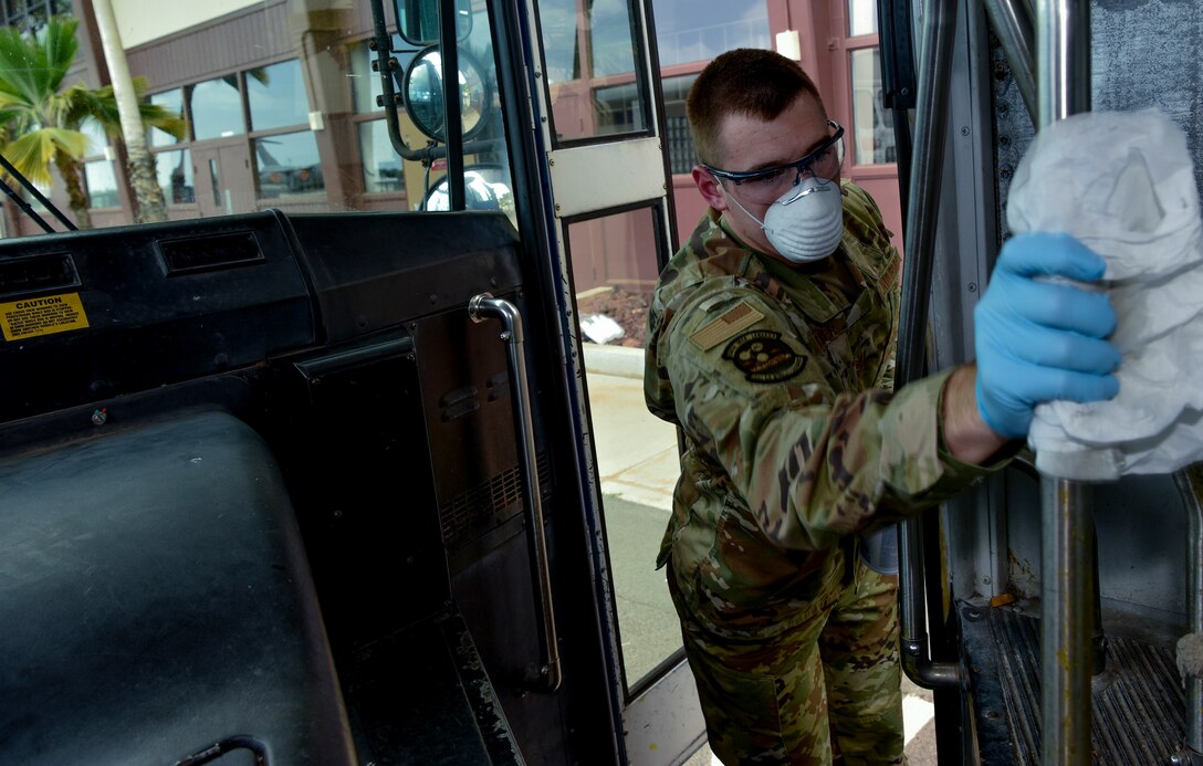 U.S. Air Force Staff Sgt. Colton Webber, 735th Air Mobility Squadron passenger terminal shift supervisor,   decontaminates the handrail after transporting passengers to and from the aircraft at Joint Base Pearl Harbor-Hickam, Hawaii, March 25, 2020.

U.S. Indo-Pacific Command (INDOPACOM) directed implementation of Health Protection Condition (HPCON) Charlie March 24, 2020. 

(U.S. Air Force photo by Tech. Sgt. Anthony Nelson Jr. )