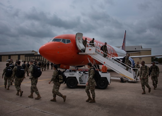 Basic Military Training graduates off load from a plane at Sheppard Air Force Base, Texas, March 27, 2020. Usually the newest Airmen will arrive by bus to Sheppard, but to mitigate exposure Air Education and Training command opted to transport them via air lift. The airlines are contracted with the Air Force to pick up the Airmen in Lackland and transport them to Sheppard, Keesler AFB and other training bases. (U.S. Air Force photo by Senior Airman Pedro Tenorio)