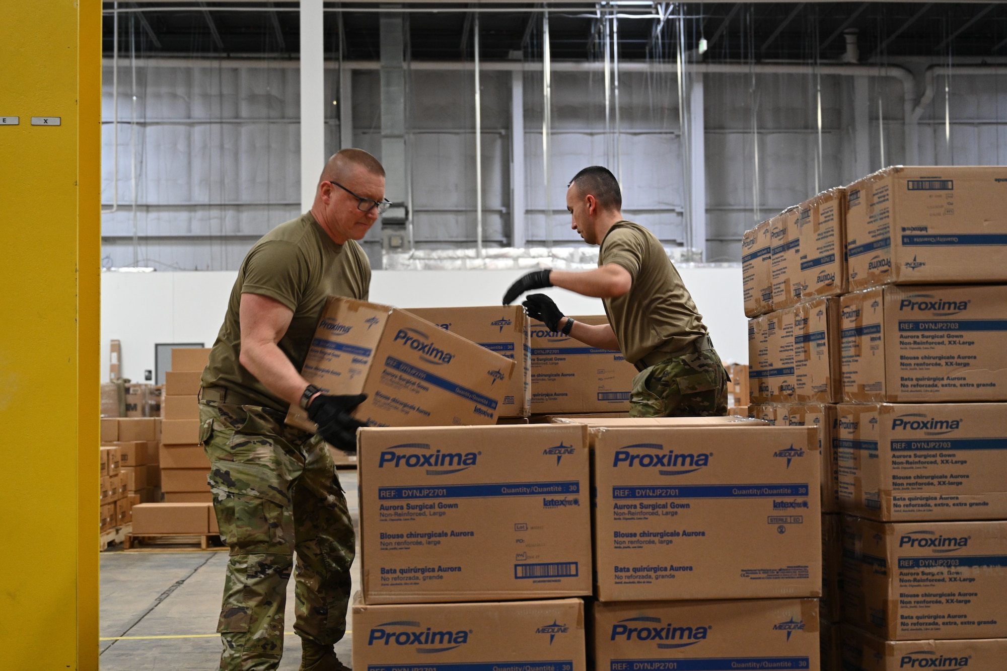 (From left) U.S. Air Force Master Sgt. Richard Malloy and U.S. Air Force Tech. Sgt. Bradly Tuthill, both ground transportation specialists with the 175the Logistics Readiness Squadron, prepare and load boxes of medical supplies and equipment March 19, 2020, at the Maryland Strategic National Stockpile location. All assets provided were prioritized for health care workers and hospitals in response to the COVID-19 pandemic. (U.S. Air National Guard photo by Master Sgt. Christopher Schepers)