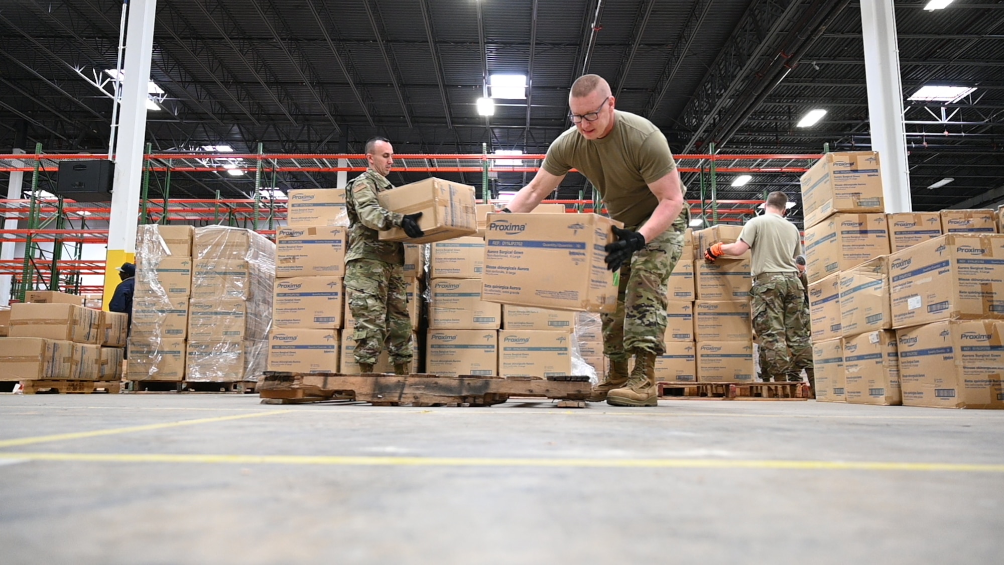 (From left) U.S. Air Force Tech. Sgt. Bradly Tuthill and U.S. Air Force Master Sgt. Richard Malloy, both ground transportation specialists with the 175the Logistics Readiness Squadron, prepare and load boxes of medical supplies and equipment March 19, 2020, at the Maryland Strategic National Stockpile location. All assets provided were prioritized for health care workers and hospitals in response to the COVID-19 pandemic. (U.S. Air National Guard photo by Master Sgt. Christopher Schepers)