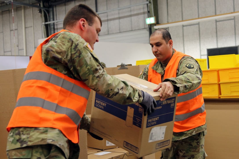 U.S. Army Reserve Sgt. Farid Tehrani, right, a supply sergeant with Medical Support Unit-Europe, 7th Mission Support Command, and U.S. Army Sgt. Roger Rood, a biomedical equipment specialist with the 8th Medical Logistics Company, 421st Multifunctional Medical Battalion, 30th Medical Brigade, 21st Theater Sustainment Command, load boxes of medical supplies onto a pallet at the U.S. Army Medical Materiel Center, Europe warehouse in Pirmasens, Germany, March 26, 2020. 7th MSC and 21st TSC Soldiers are supporting the shipping and receiving functions in the warehouse to help with the high demand of Army Class VIII medical supplies during the COVID-19 pandemic.