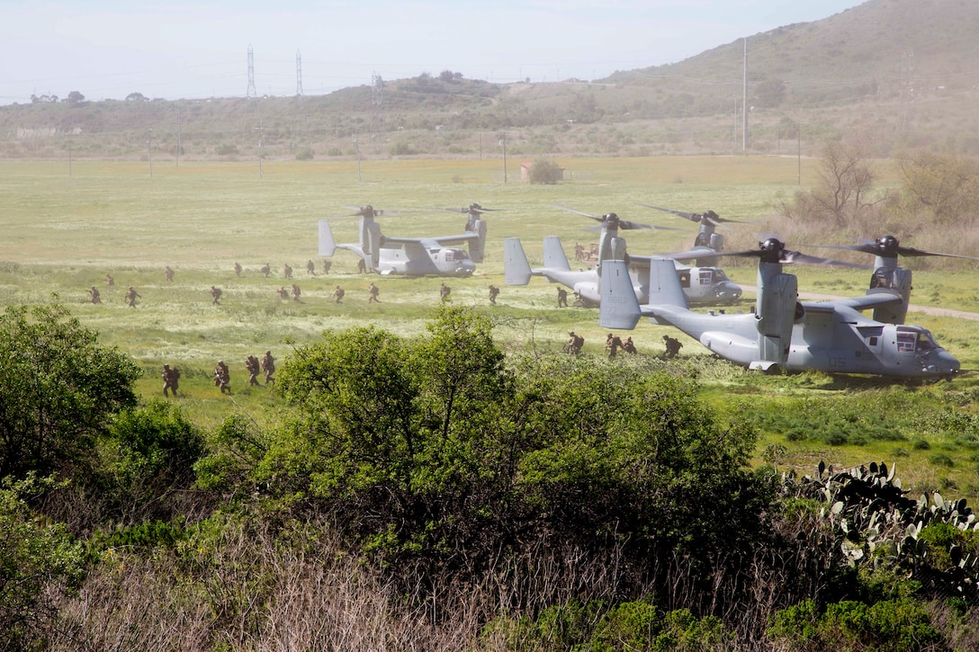 Three MV-22B Ospreys assigned to Marine Tiltrotor Squadron (VMM) 362, Marine Aircraft Group (MAG) 16, 3rd Marine Aircraft Wing (MAW), insert Marines at a simulated weapons engagement zone during an air assault in support of 1st Battalion, 3rd Marine Regiment, at Camp Pendleton, Calif., Feb. 26, 2020. Air assaults enable commanders to avoid enemy surfaces, exploit gaps, and maintain the flexibility and mobility needed to strike objectives in otherwise inaccessible areas during a Marine Air Ground Task Force mission. This culminating event signified that VMM-362 has reached full operational capability since its reactivation in 2018, ultimately increasing the lethality of 3rd MAW. (U.S Marine Corps photo by Lance Cpl. Julian Elliott-Drouin)