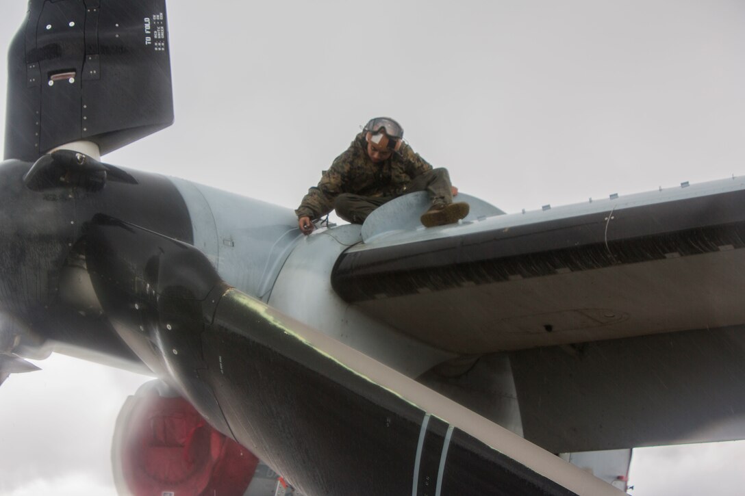 U.S. Marines with Marine Medium Tiltrotor Squadron 362, Marine Aircraft Group 16, 3rd Marine Aircraft Wing, enforce precautionary measures during the maintenance of MV-22 Osprey on Marine Corps Air Station Miramar, Calif., March 19, 2020. The purpose of these measures is to mitigate the spread of COVID-19 while continuing to perform mission essential tasks.(U.S. Marine Corps photo by Lance Cpl. Julian Elliott-Drouin)