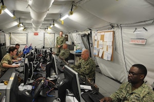 Service members assigned to the International Maritime Security Construct (IMSC) practice social distancing in the workspace. The IMSC ensures freedom of navigation and free flow of commerce in international waters throughout the Arabian Gulf, Strait of Hormuz, the Bab el-Mandeb Strait, and the Gulf of Oman.