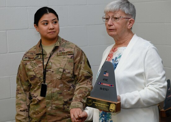 Susan Kintz, the 910th Operations Support Group resource manager, presents Staff Sgt. Mariela Love, a personnel specialist for the 910th Operations Support Squadron, with the Susan Kintz Operations Support Airman of the Year award during a morning briefing at the 910th Operations Group, March 7, 2020.