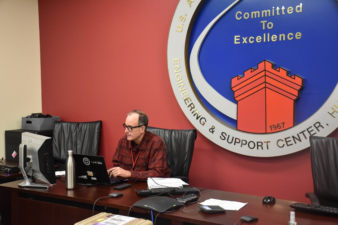 Bill Ferguson, U.S. Army Engineering and Support Center, Huntsville Emergency Operations Center operations chief, prepares notes for the U.S. Army Corps of Engineers daily commander’s telecon briefing March 25.