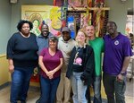 DLA Aviation Jacksonville employees pose for photo with Clara White Mission employees