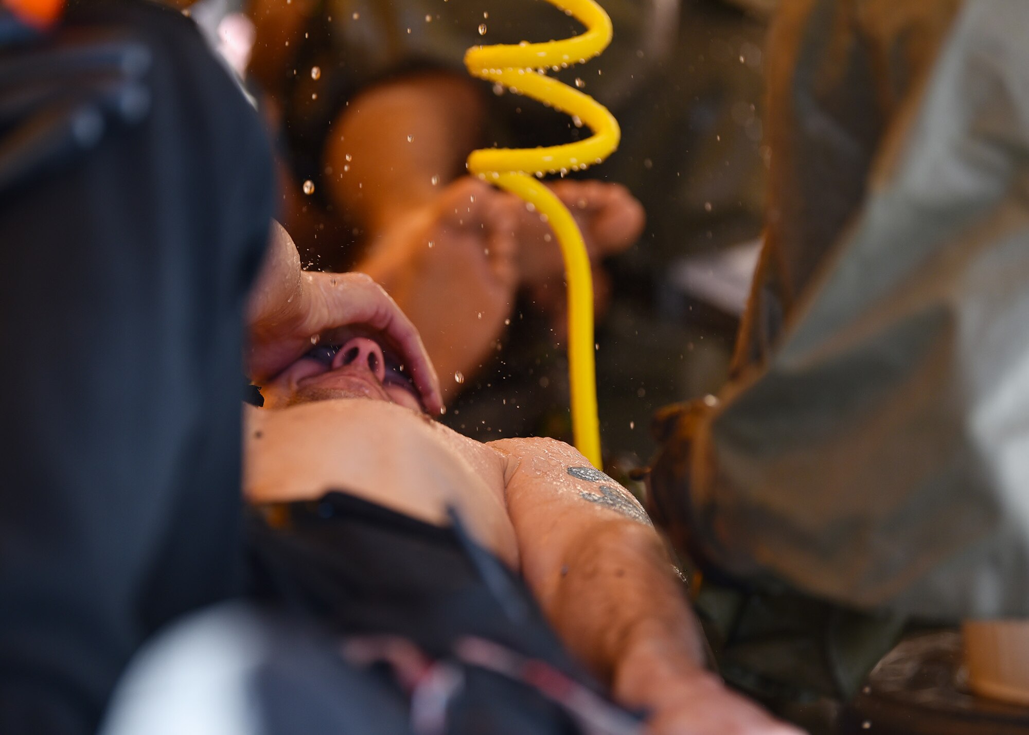 Airmen assigned to the 7th Medical Group decontaminate a simulated medical patient during a chemical, biological, radiological, and nuclear exercise at Dyess Air Force Base, Texas, March 6, 2020. Both Dyess Airmen and Abilene Christian University students volunteered as simulated medical patients to provide a sense of realism for the responding agencies. (U.S. Air Force photo by Airman 1st Class Sophia Robello)