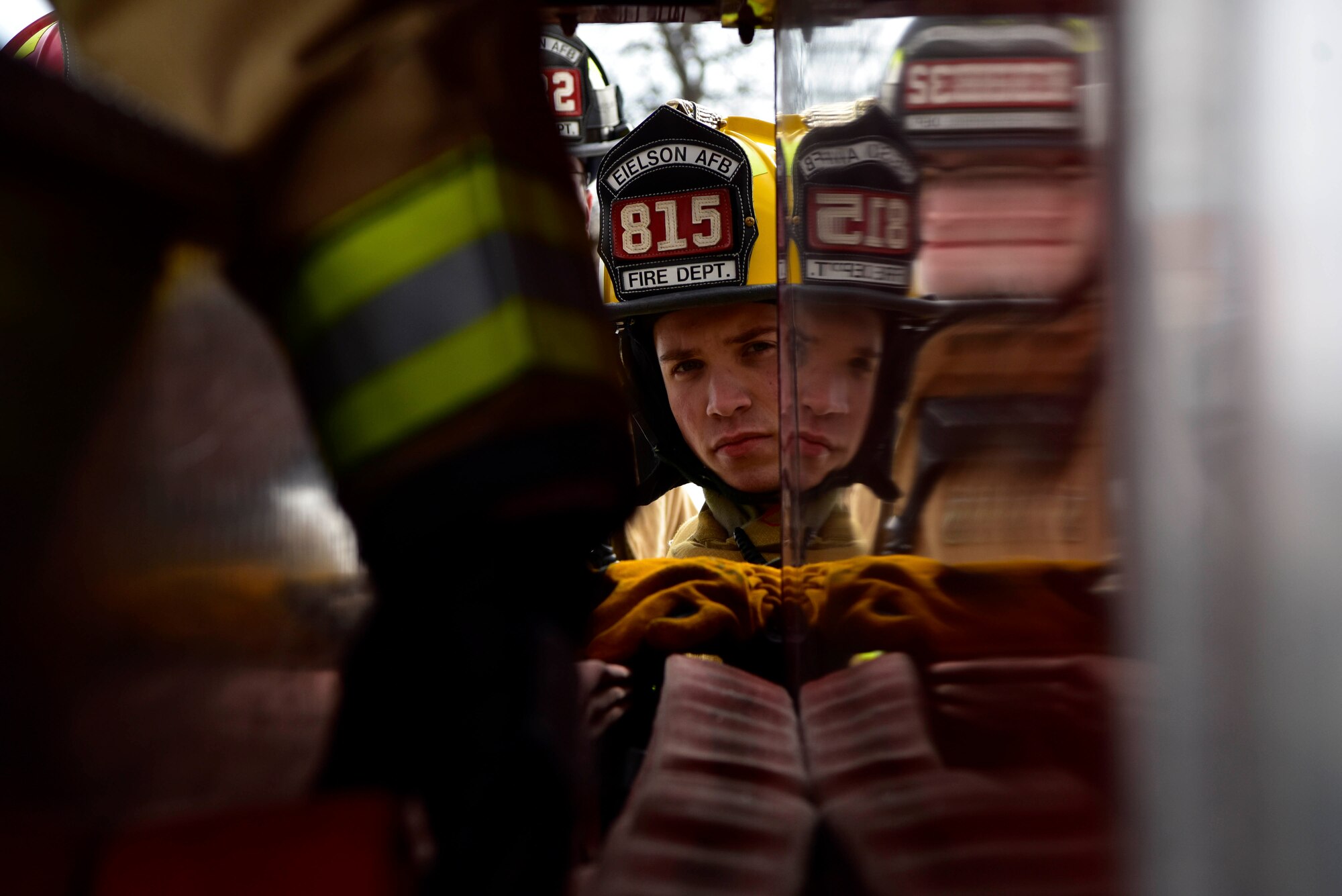 Airman 1st Class Taylor Beard, a 354th Civil Engineer Squadron firefighter, loads a hose onto a fire truck during a training exercise on Eielson Air Force Base, Alaska, March 26, 2020. The Eielson fire department is unique because one day they are responding to a wildfire and the next they are rescuing someone who is suffering from cold weather exposure. (U.S. Air Force photo by Senior Airman Beaux Hebert)