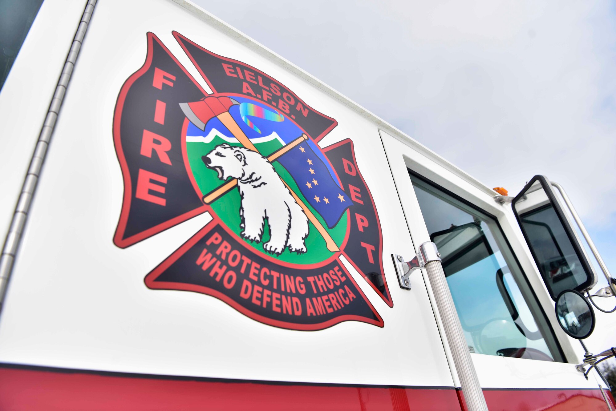 The 354th Civil Engineer Squadron fire department emblem on the side of a firetruck on Eielson Air Force Base, Alaska, March 26, 2020. Eielson firefighters respond to different types of calls including fire and medical emergencies, accidents involving hazardous materials and incidents on the flight line. (U.S. Air Force photo by Senior Airman Beaux Hebert)