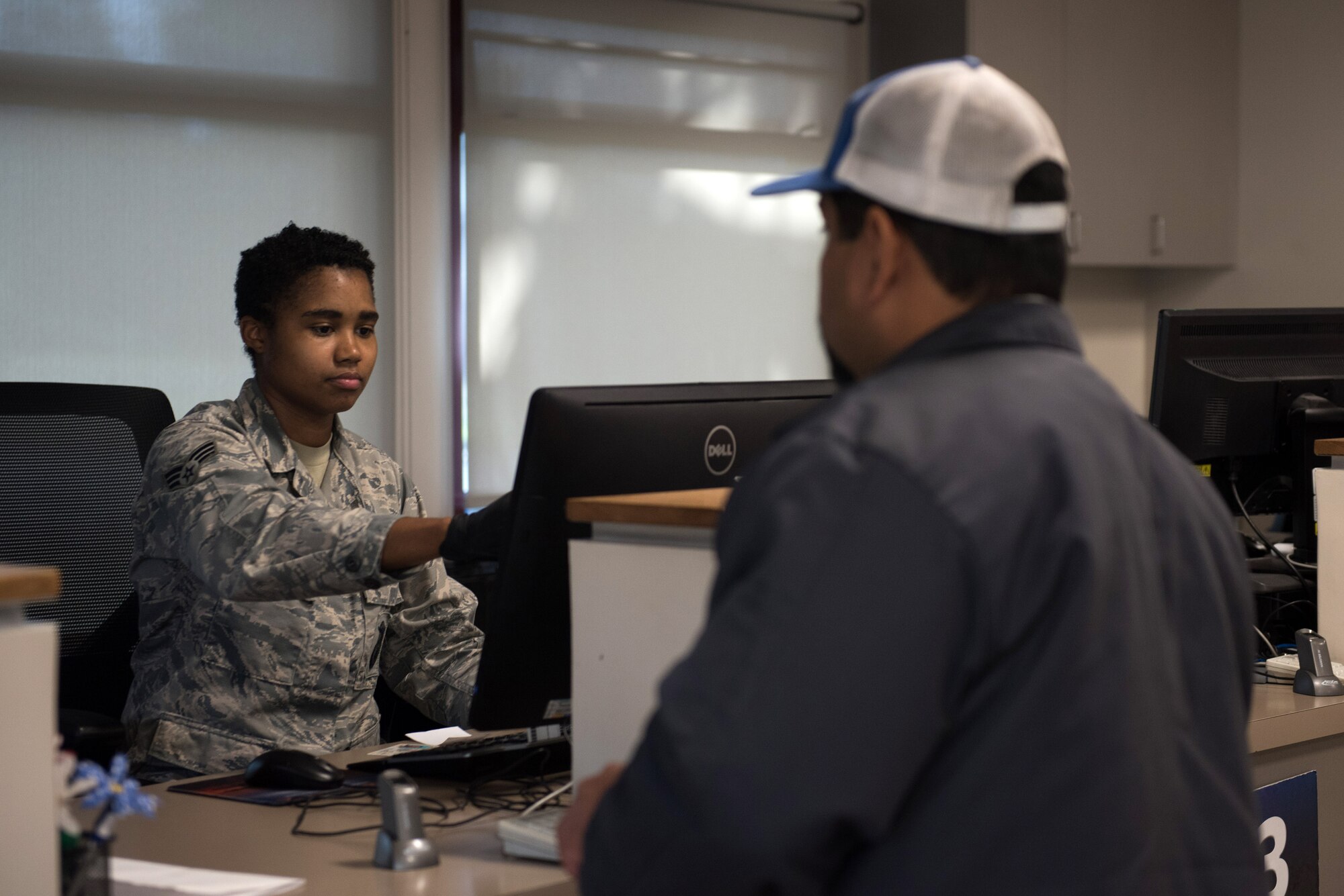 Photo of Airman and customer at visitor center