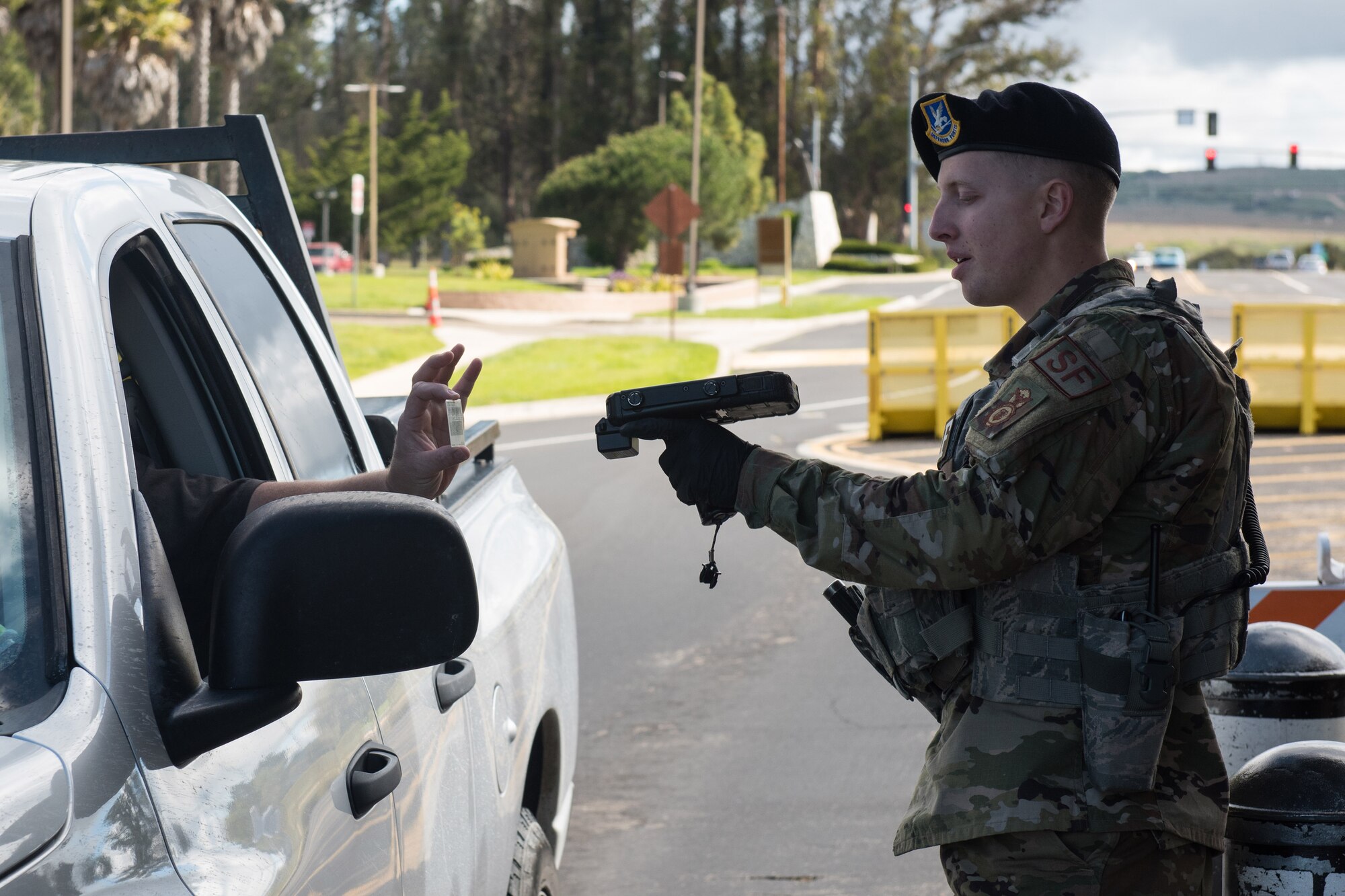 Photo of Airman checking ID at the gate