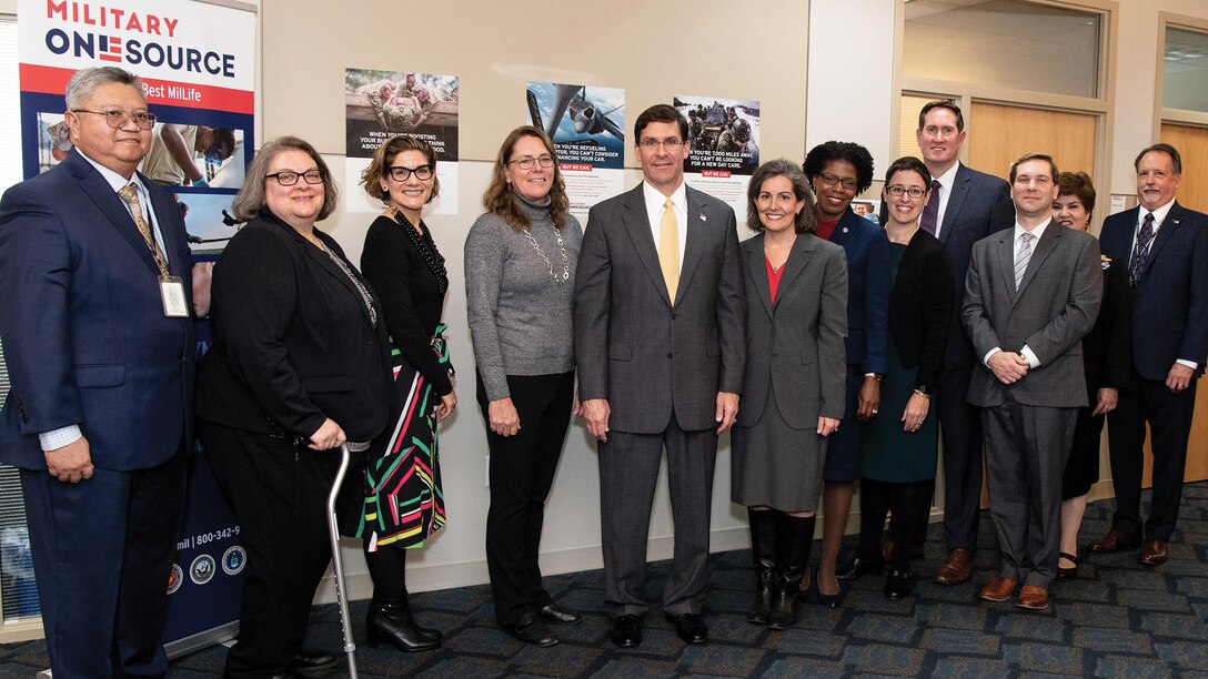 Defense secretary and his wife pose for a photo with 10 call center workers.