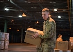 Sgt. Evan Dupree, 1048th Medium Truck Company transportation specialist, organizes boxes containing personal protective equipment at a warehouse in New Britain, Connecticut, March 30, 2020. The Connecticut National Guard  is helping distribute personal protective equipment, medical supplies, and medical equipment in response to the COVID-19 pandemic.