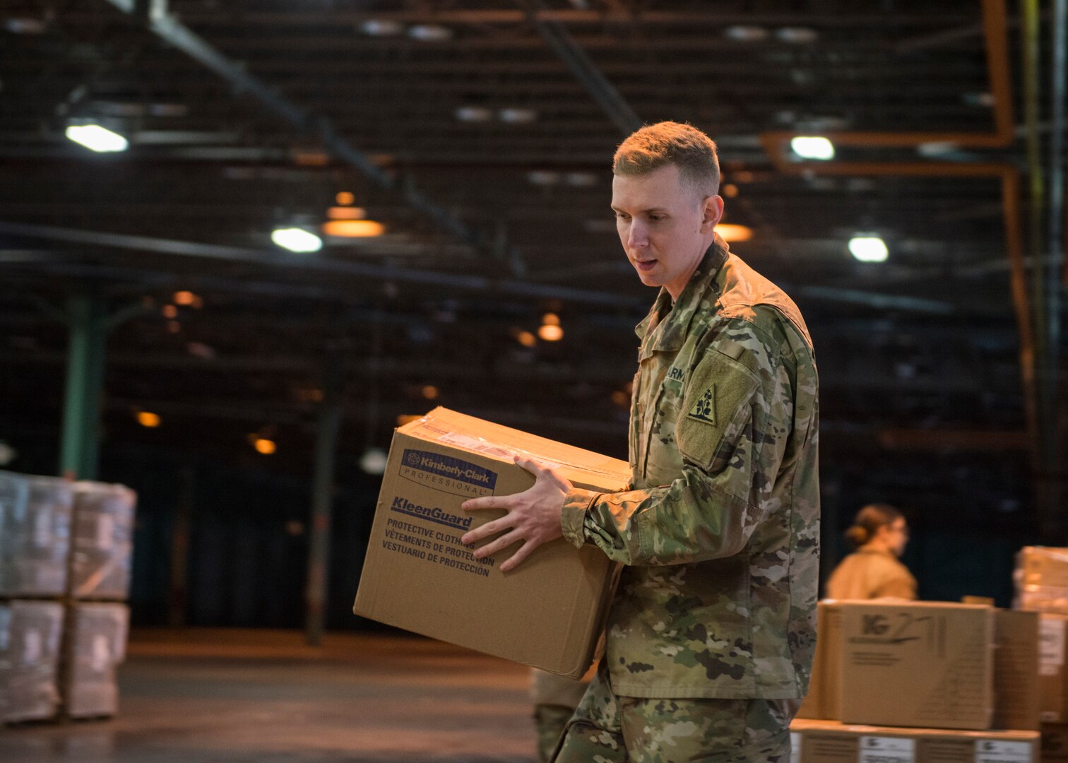 Sgt. Evan Dupree, 1048th Medium Truck Company transportation specialist, organizes boxes containing personal protective equipment at a warehouse in New Britain, Connecticut, March 30, 2020. The Connecticut National Guard  is helping distribute personal protective equipment, medical supplies, and medical equipment in response to the COVID-19 pandemic.