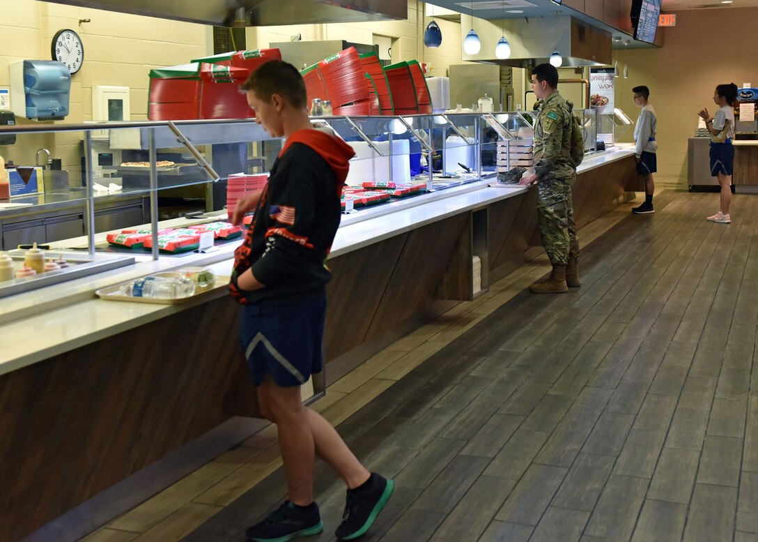 Students practice safe social distancing while at the Western Winds Dining Facility on Goodfellow Air Force Base, Texas, March 30, 2020. Due to the COVID-19 virus, it is encouraged to avoid large gatherings and stand at least six feet apart whenever possible. (U.S. Air Force photo by Senior Airman Seraiah Wolf)