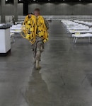 U.S. Air Force Tech. Sgt. Jarrett Boyd, a structures supervisor with the California Air National Guard's 146th Airlift Wing, sets up power cords in support of a federal medical station for COVID-19 response at the Los Angeles Convention Center, March 29, 2020. The wing set up additional medical stations in the California cities of Indio and Santa Clara.