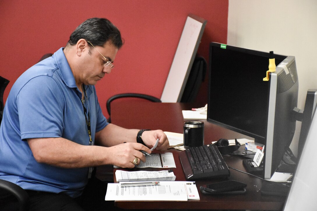 Antonio Santoscruz, U.S. Army Engineering and Support Center, Huntsville Emergency Operations Center operations and plans specialist, compiles data for the U.S. Army Corps of Engineers daily commander’s telecon briefing March 25.