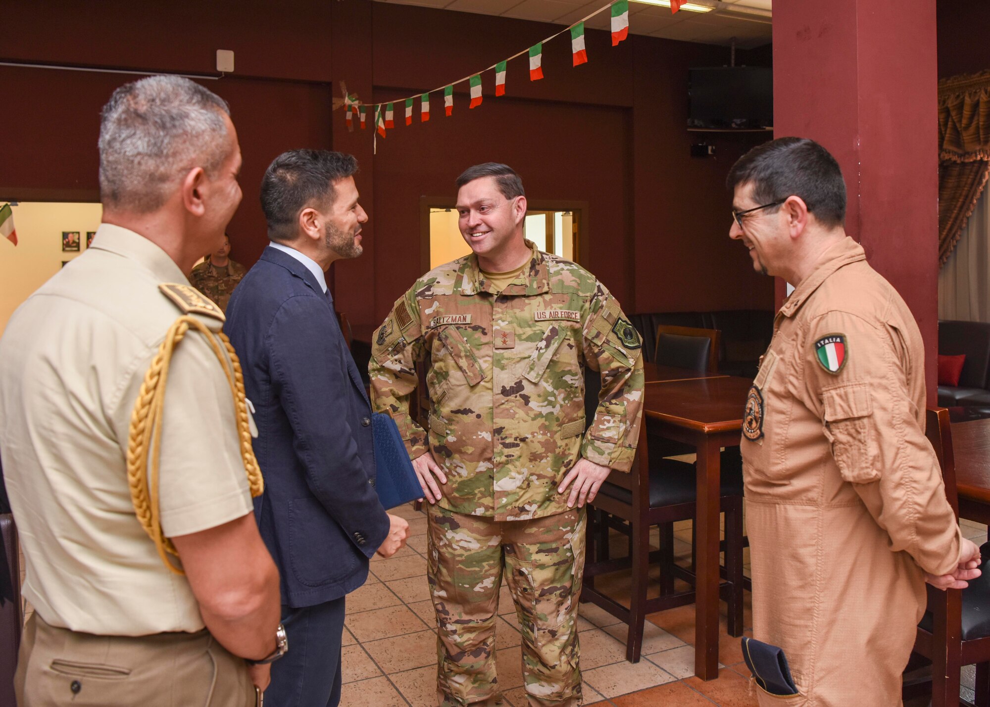 U.S. Air Force Maj. Gen. B. Chance Saltzman, U.S. Air Forces Central Command deputy Combined Force Air Component Commander, speaks with Italian leaders and military members during an Italian National Day celebration at Al Udeid Air Base, Qatar, June 8, 2019.