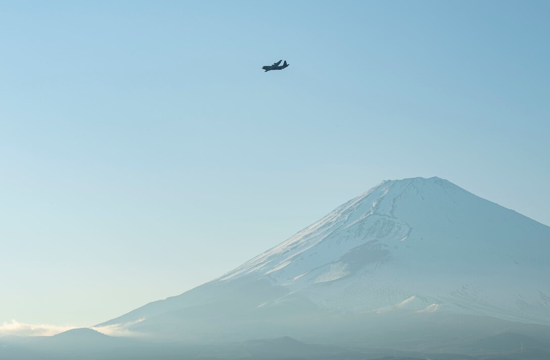 A C-130J Super Hercules assigned to the 36th Airlift Squadron, Yokota Air Base, Japan, flies over the Combined Arms Training Center, Camp Fuji, Japan