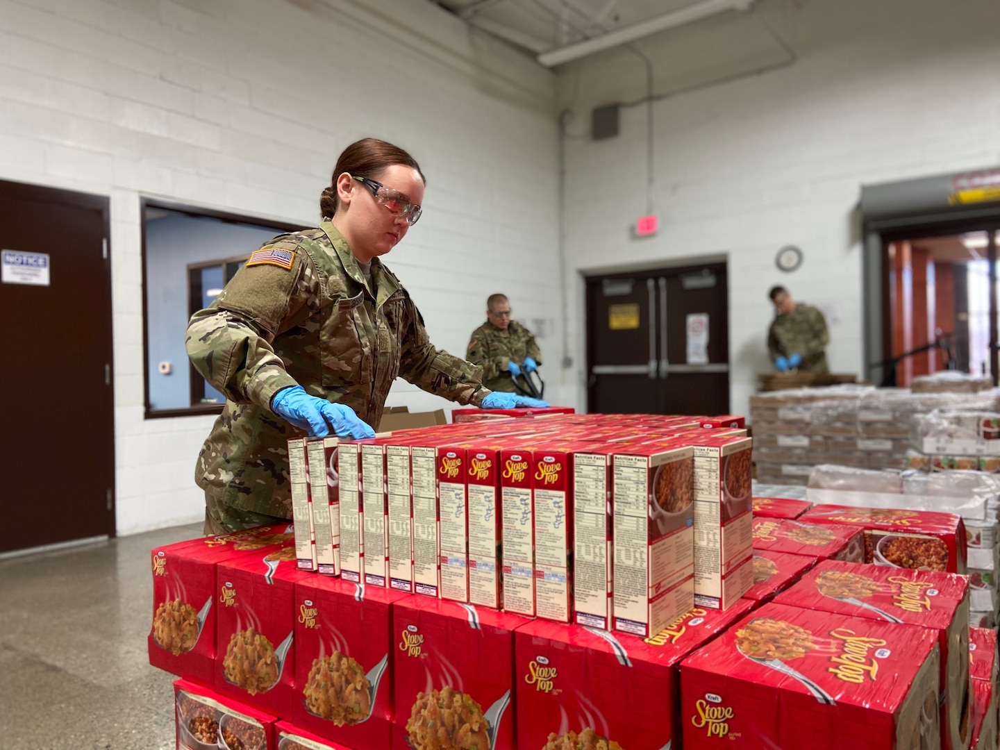 Michigan National Guard members support the distribution of food for families in need during the state’s response to COVID-19 at the Food Bank of Eastern Michigan, Flint, Mich., March 30, 2020. About 40 Michigan Guard members are helping at four Michigan food banks for several weeks.