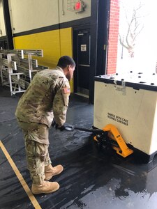 Soldiers from the 103rd Engineer Battalion, Pennsylvania National Guard, help the Federal Emergency Management Agency unload equipment at the a school in Glen Mills, Pa., to establish a federal medical station for non-COVID 19 patients should regional hospitals become full.