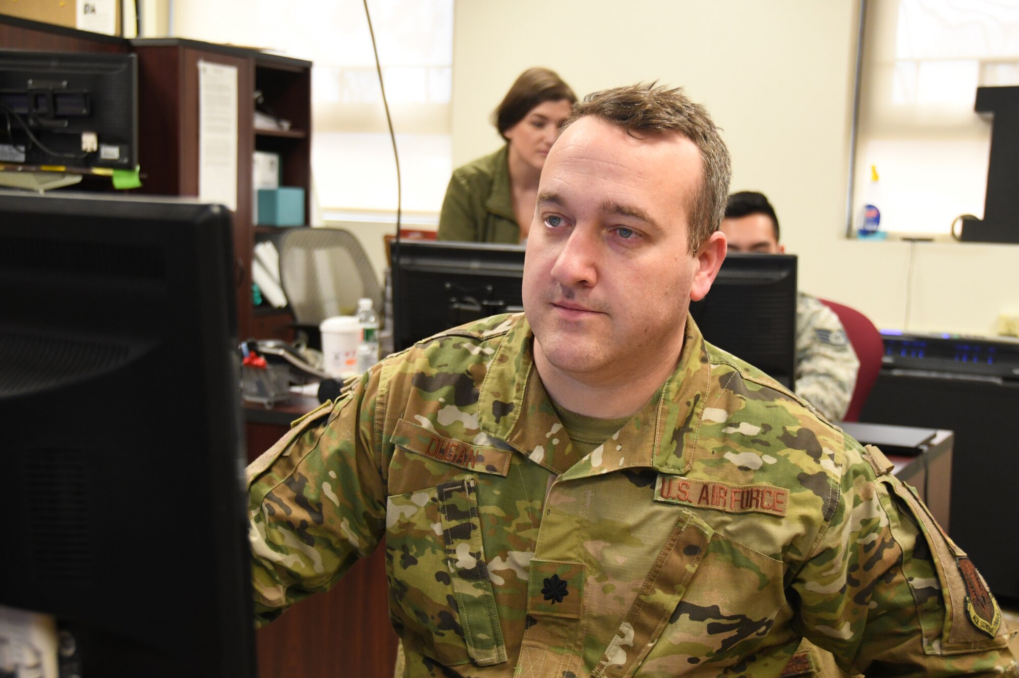 Lt. Col. Jeremy Dugan 104th Fighter Wing Emergency Operations Center commander, monitors, and coordinates with the Emergency Operation Center on critical information requests in response to COVID-19, March 30, 2020. Dugan serves in the Air National Guard in his community of Western Massachusetts. (U.S. Air National Guard Photo by Senior Master Sgt. Julie Avey)