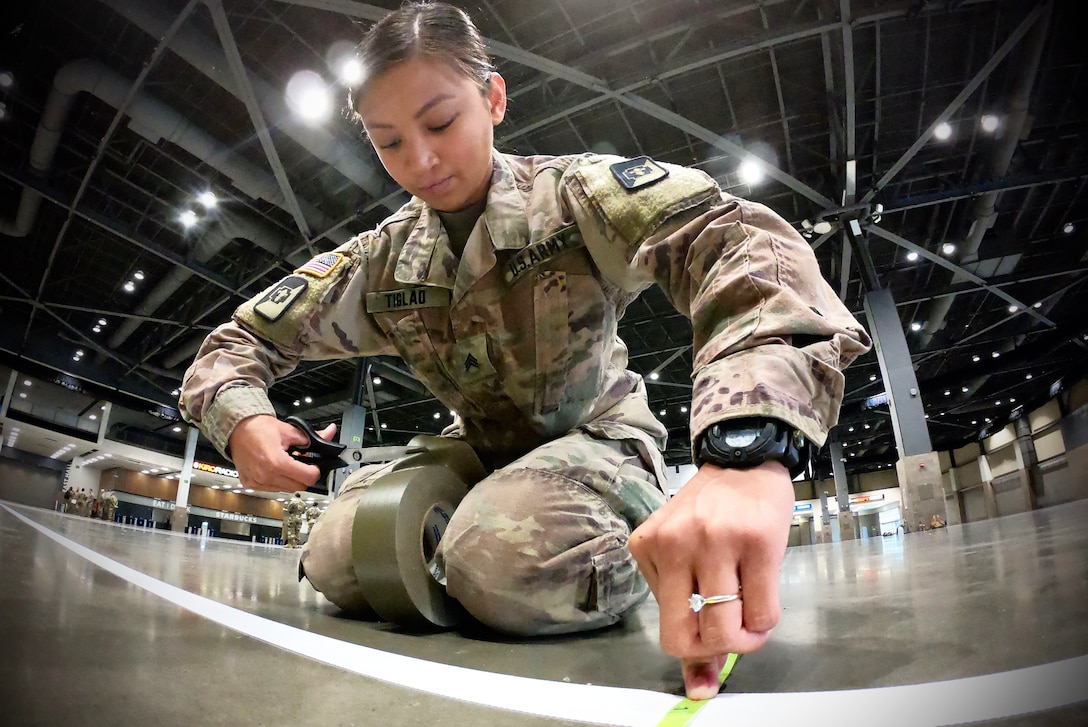 A soldier lays down tape.