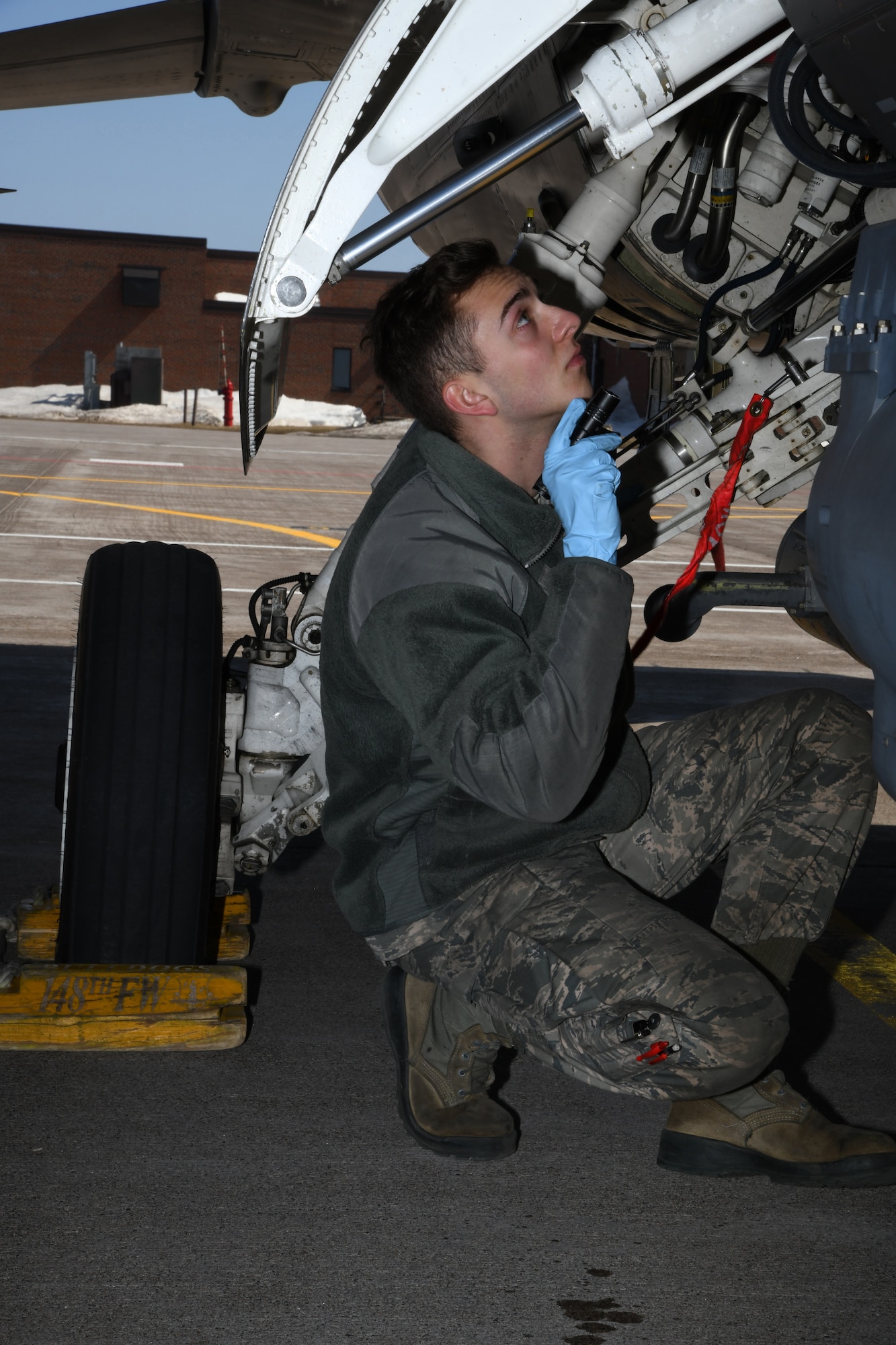 An aircraft maintenance technician looks over a Block 50 F-16CM Fighting Falcon upon its' return from an Operation NOBLE EAGLE deployment