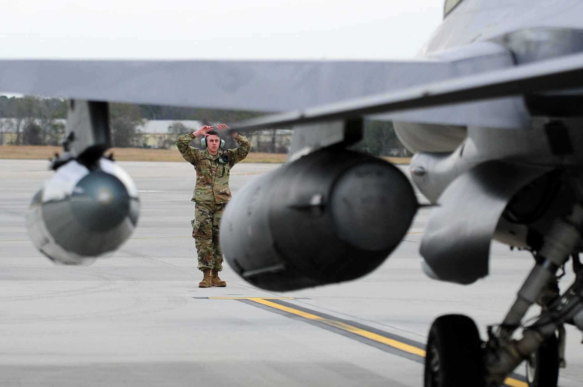 A crew chief from the 148th Fighter Wing recovers a Block 50, F-16 while deployed in support of a NORAD tasked Operation NOBLE EAGLE mission