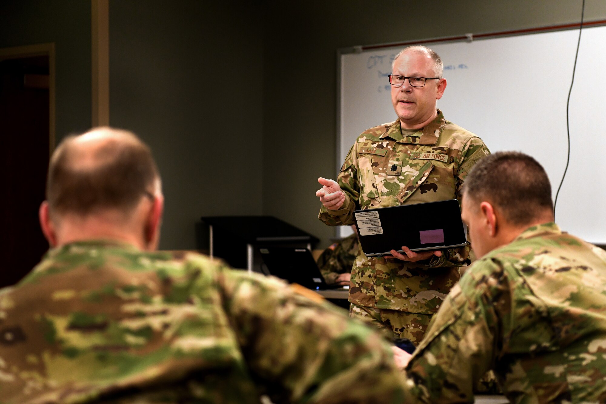 Image of U.S. Air Force Lt. Col. Gary Katz, a flight surgeon assigned to the 178th Wing serving on Joint Task Force-37, speaking to an audience.