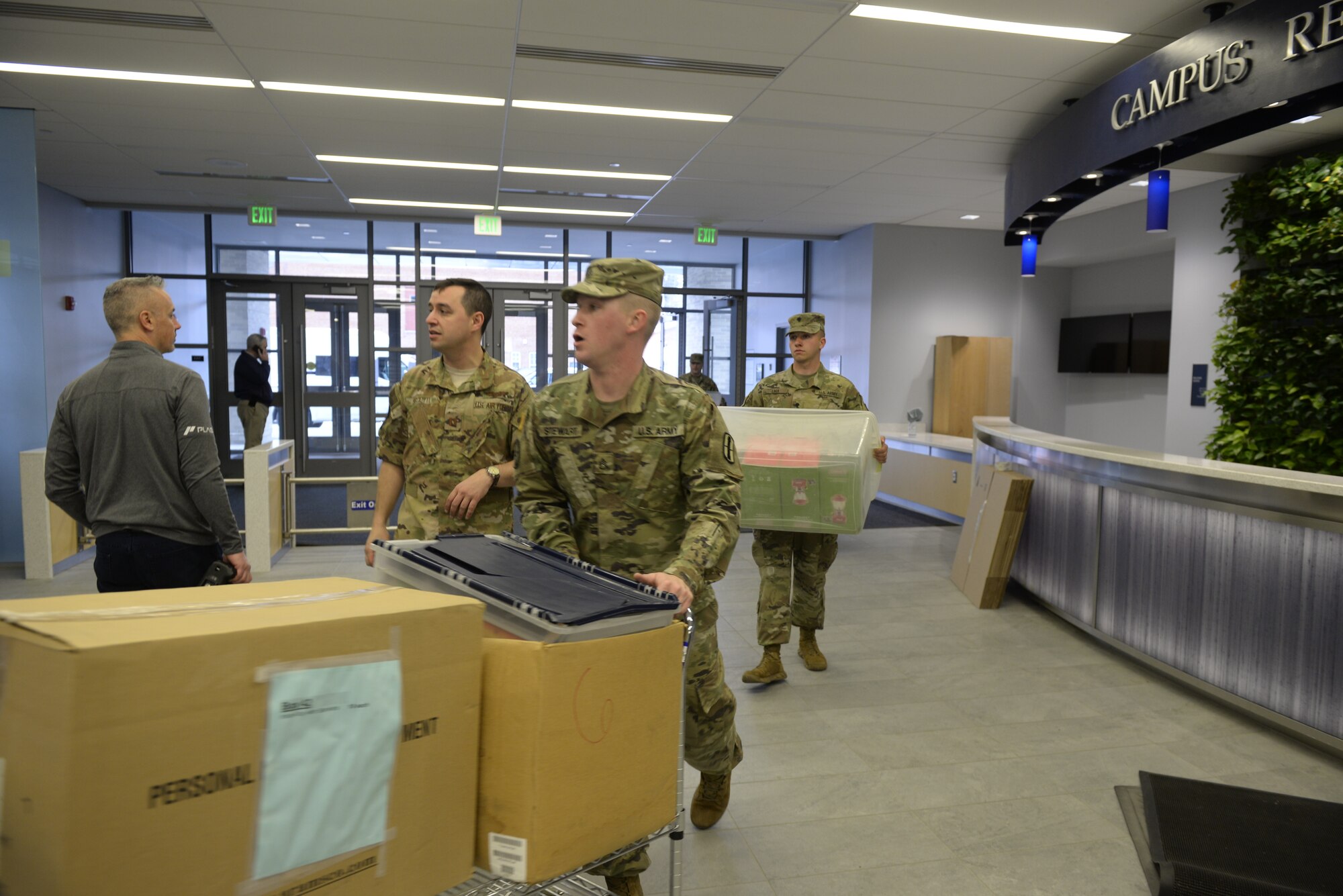 New Hampshire National Guardsmen bring medical supplies into the Hamel Recreation Center at the University of New Hampshire, March 25, 2020. The facility will augment area hospitals treating COVID-19 cases, if necessary. It is one of nine the NHNG plans to set up and manage across the state. (U.S. Air National Guard photo by Tech. Sgt. Aaron Vezeau)