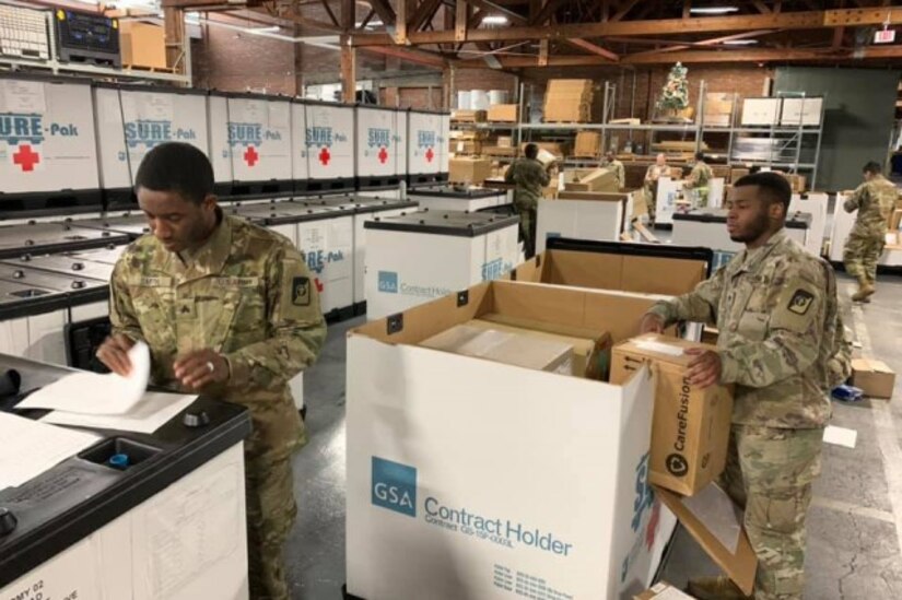 Soldiers from the 551st Medical Company (Logistics) and the 627th Hospital Center unload tri-walls of medical supplies as they arrive at Joint Base Lewis McChord, Washington, in support of COVID-19 relief efforts. (Photo Credit: U.S. Army)